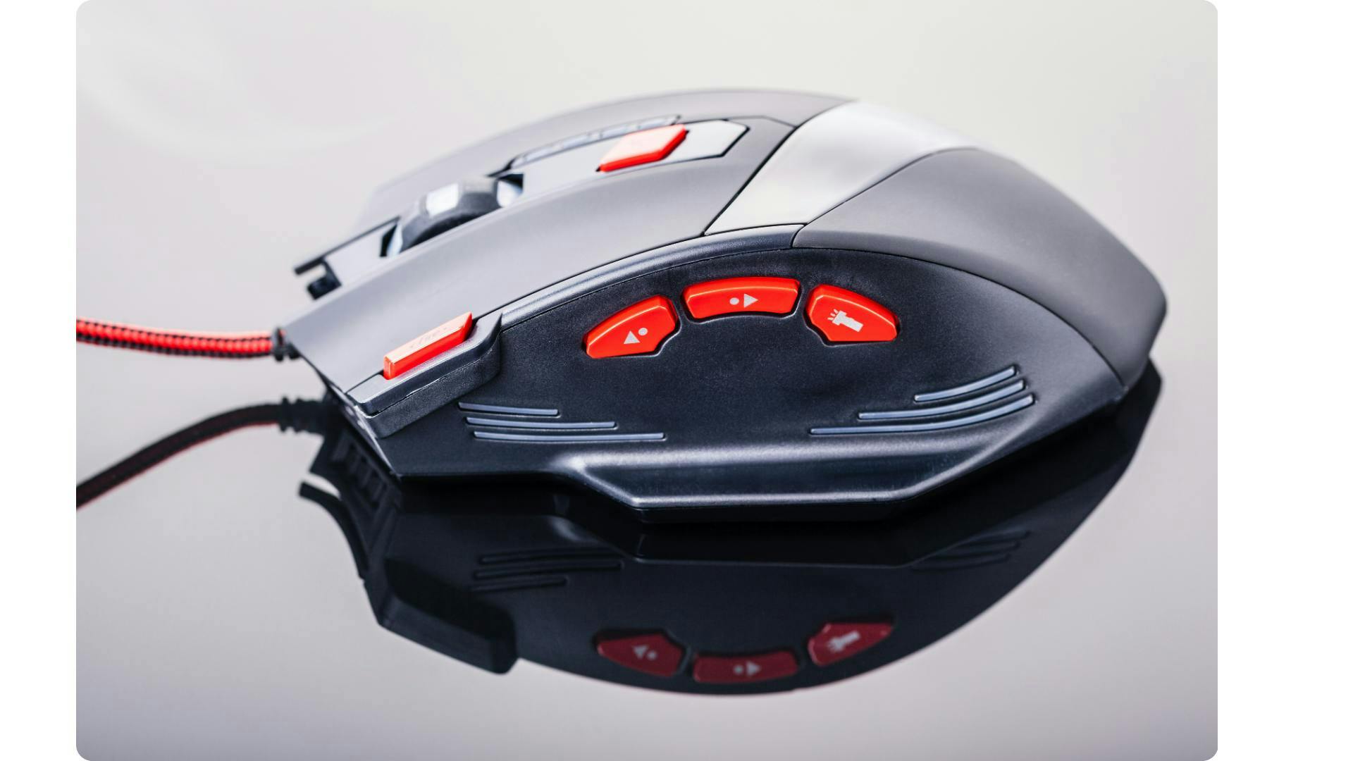 A gaming mouse viewed from the side with multiple additional buttons. | Credit: Canva.