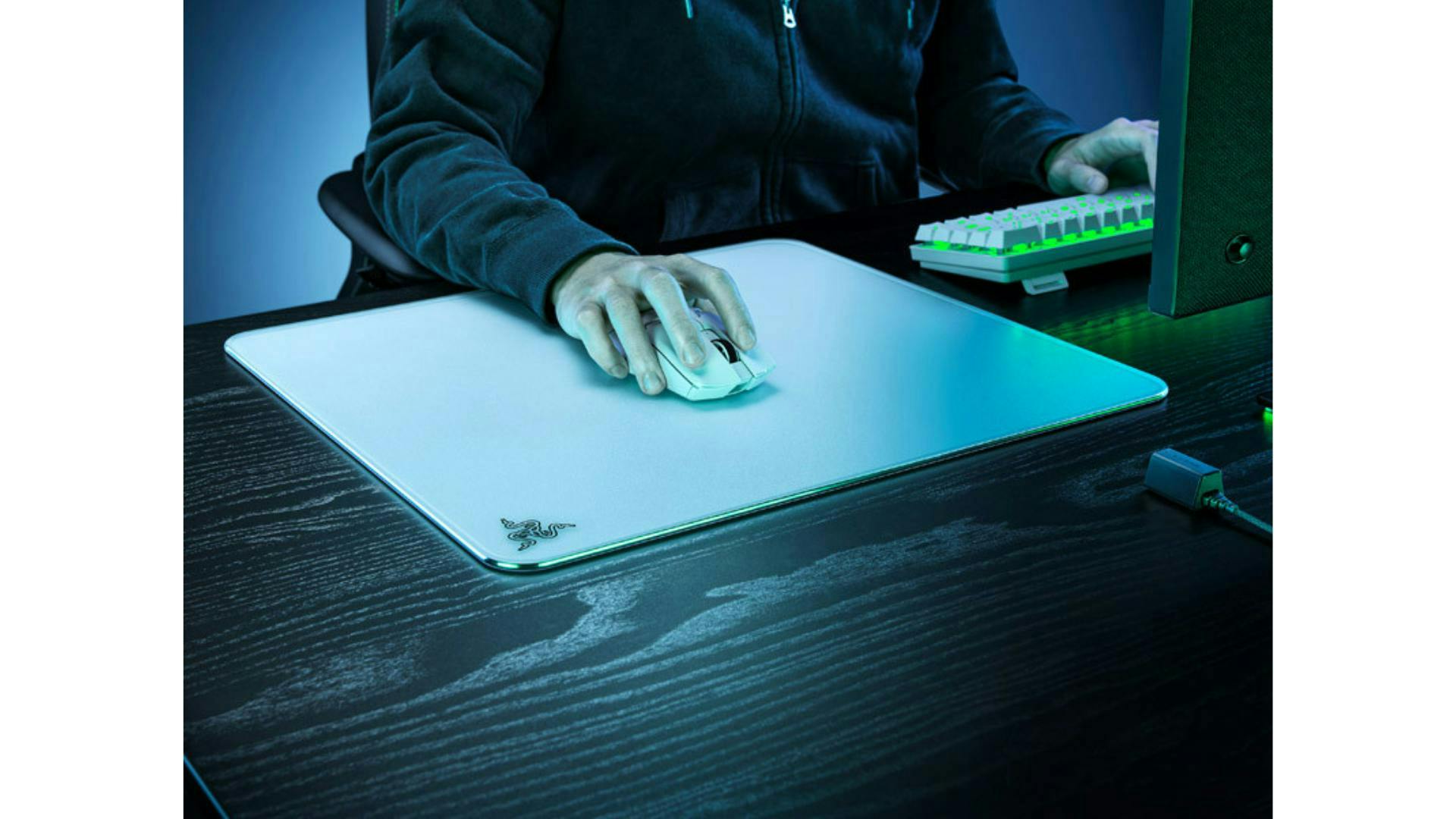 Someone is sitting at a desk using a white glass gaming mouse pad. | Credit: CaseKing.