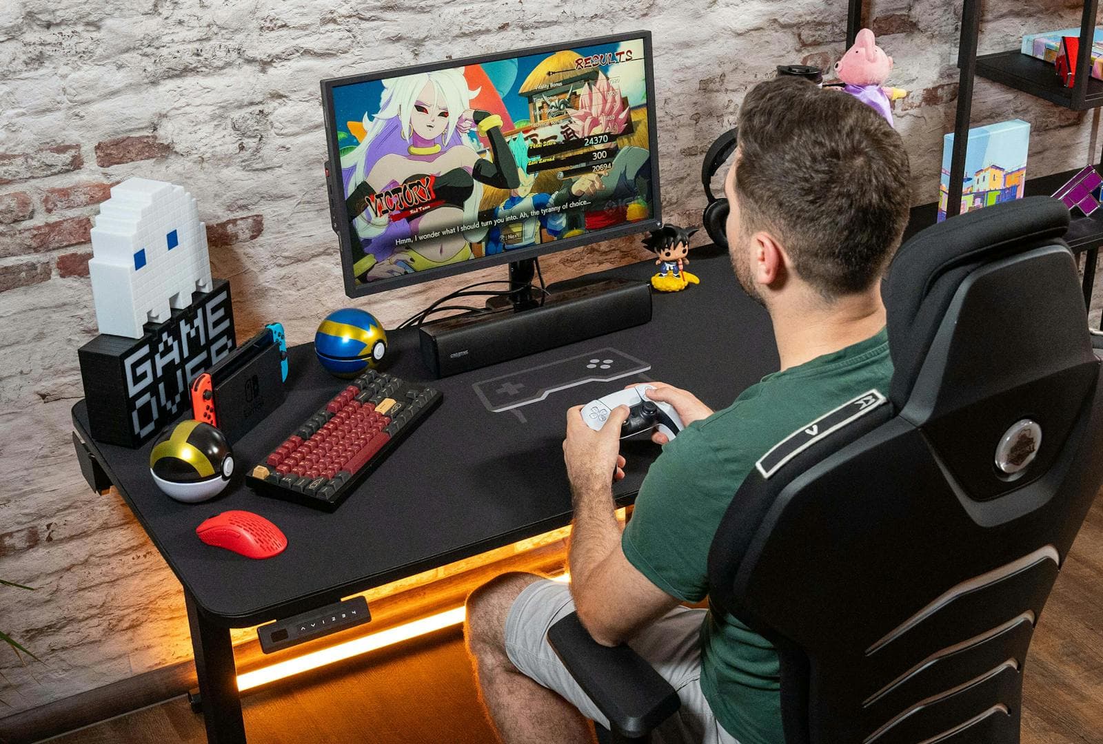 A gamer playing on a Leetdesk with a full desktop setup, featuring a black deskpad with a large mousepad surface. The mauspad is used for precise control while gaming.