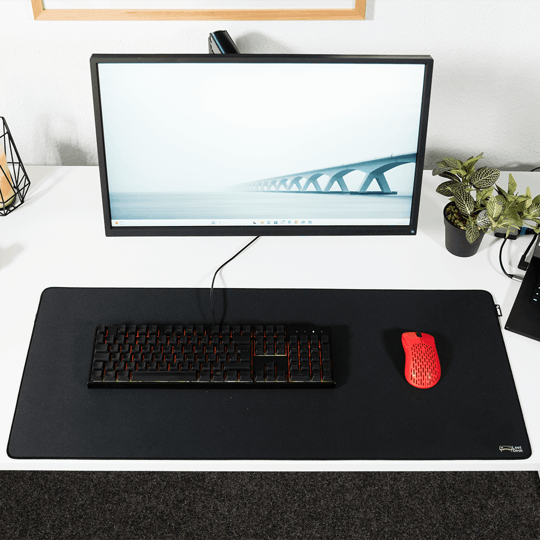 Black low-key gaming mouse pad with a small LeetDesk logo in the bottom right corner.